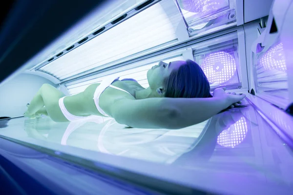Beautiful woman tanning in solarium — Stock Photo, Image
