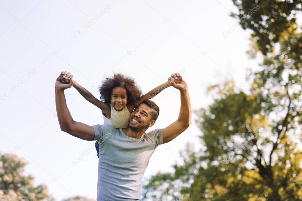 Father carrying daughter piggyback