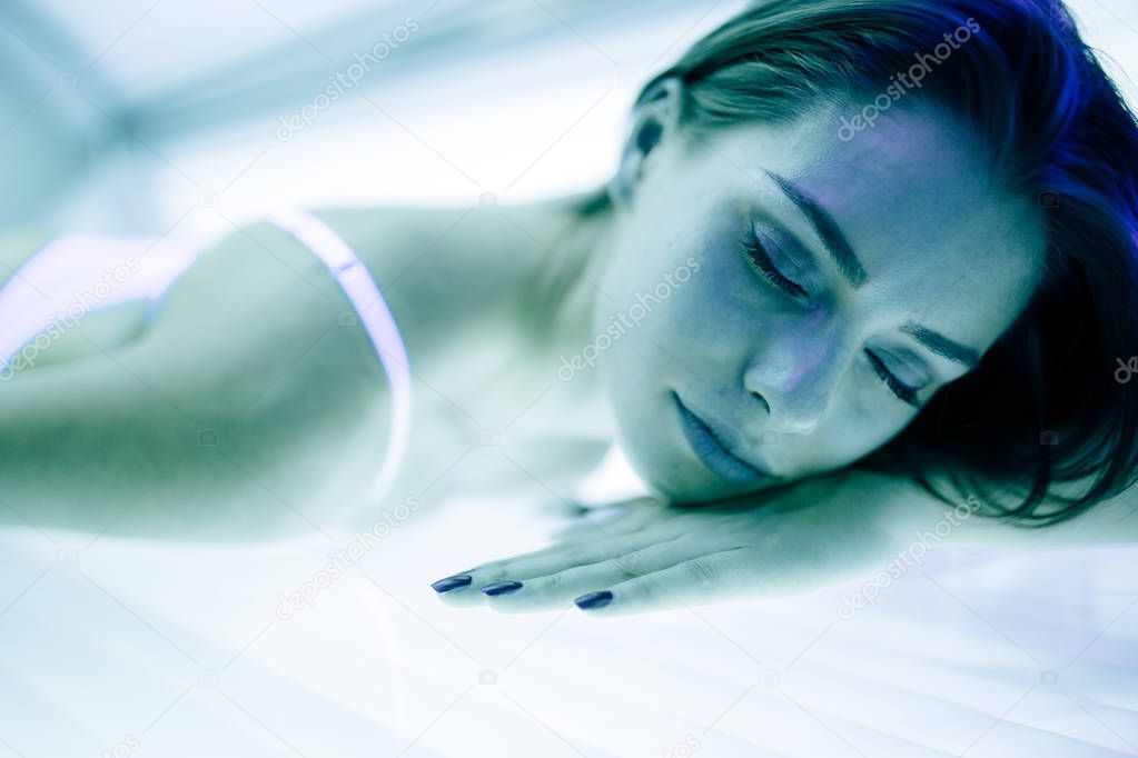 Beautiful woman lying in solarium