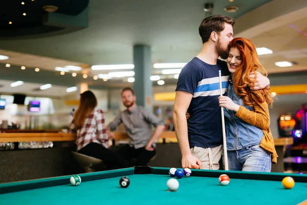 Beautiful couple playing billiards — Stock Photo, Image