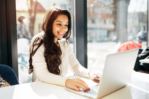 Beautiful brunette using notebook — Stock Photo, Image