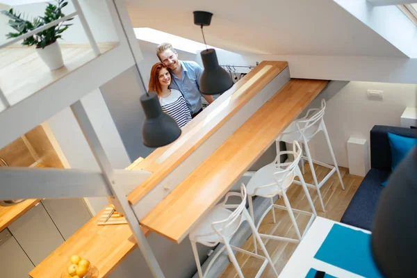 Beautiful couple in well designed kitchen — Stock Photo, Image