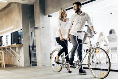 Business people on twin bicycle clipart