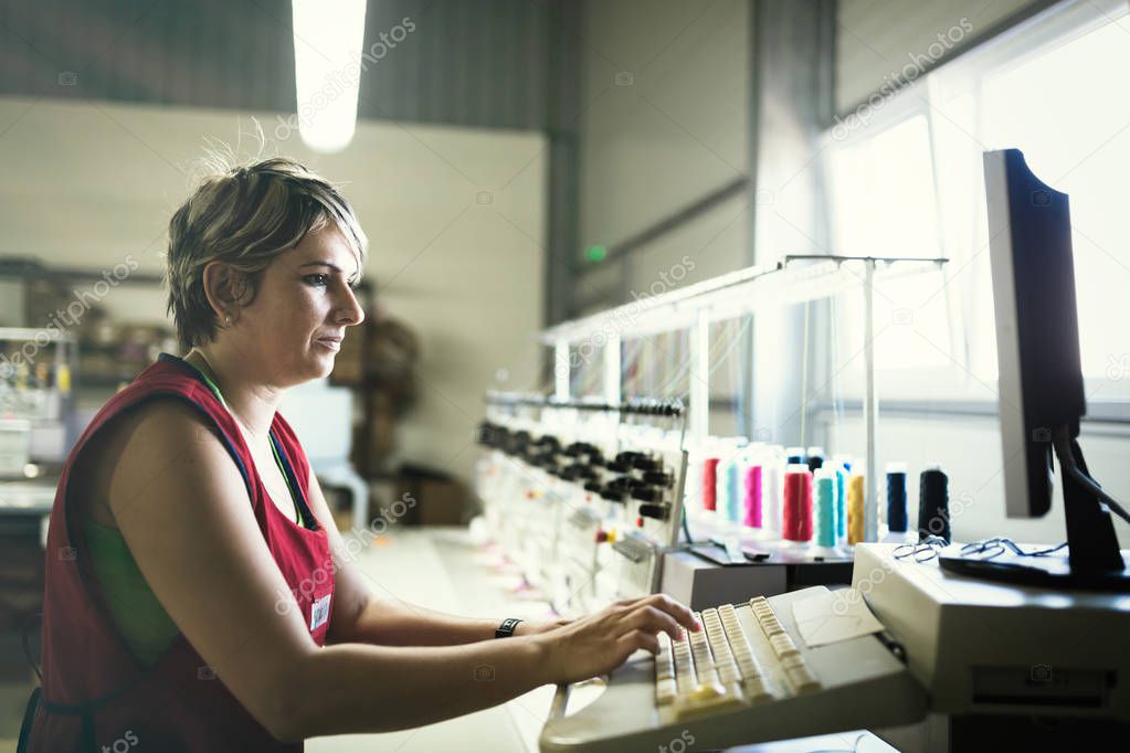 Female working on clothing fabric 