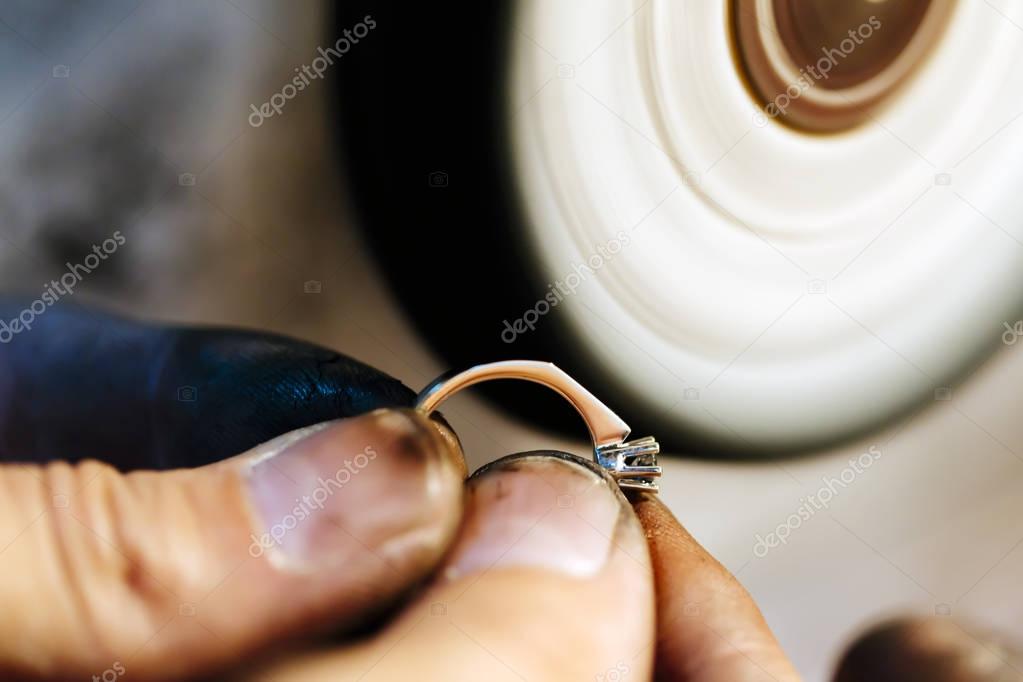 Jeweler polishing jewelry