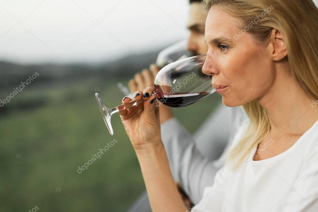People tasting wine outdoors