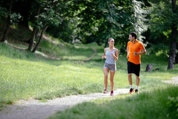 Couple jogging outdoors — Stock Photo, Image