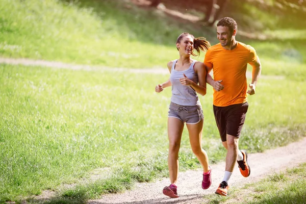 Couple jogging outdoors — Stock Photo, Image