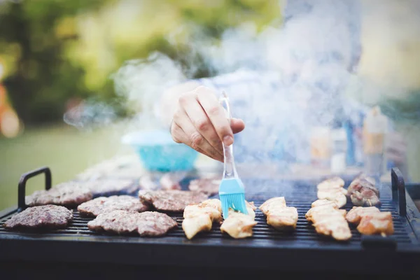 Handsome male grilling meat — Stock Photo, Image