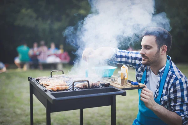 male preparing bbq meat