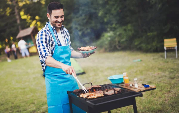 Handsome male preparing barbecue — Stock Photo, Image
