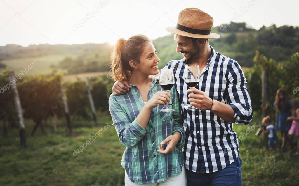 Happy people tasting wine