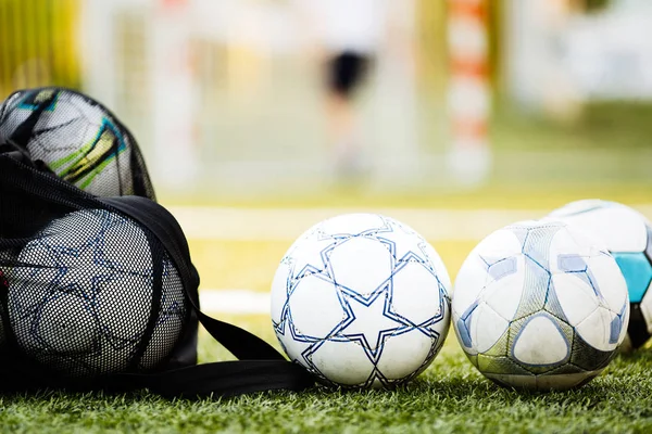 Soccer balls on football pitch — Stock Photo, Image