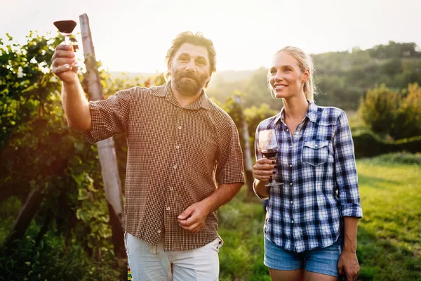 Winegrower family tasting wine