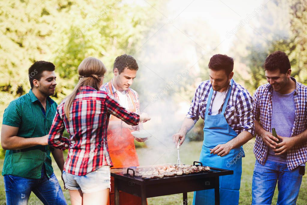 Happy friends enjoying barbecue party