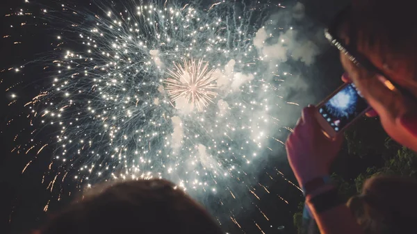 Woman taking photo of fireworks — Stock Photo, Image