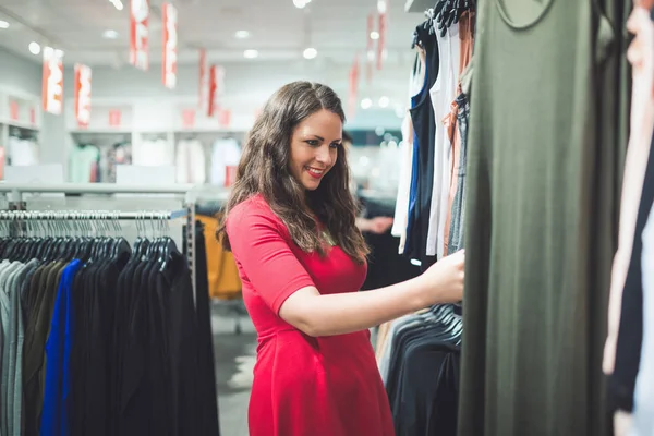 Brunette shopping for clothes — Stock Photo, Image