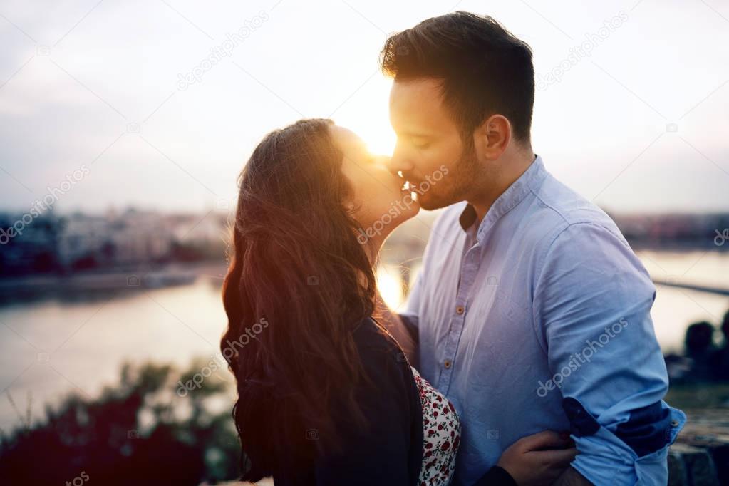 couple kissing during sunset