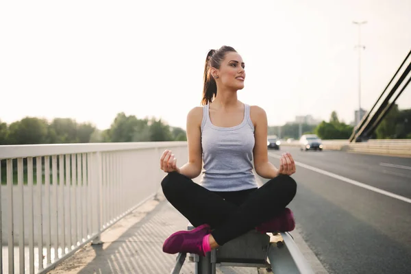 Woman sitting in lotus pose — Stock Photo, Image