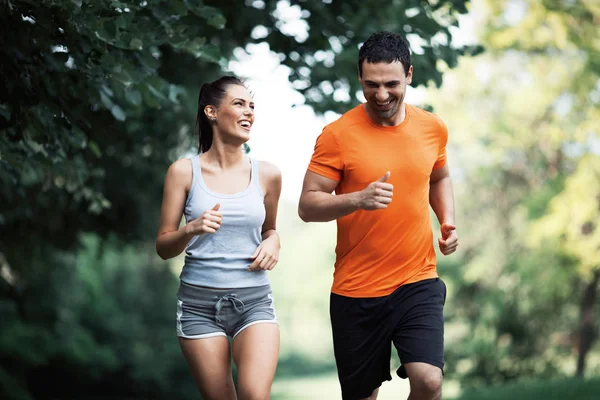 Happy couple running together Stock Image