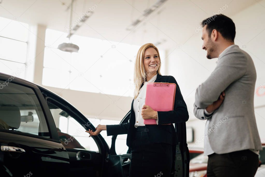 woman selling cars at dealership