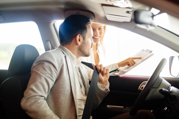 beautiful blonde woman selling cars