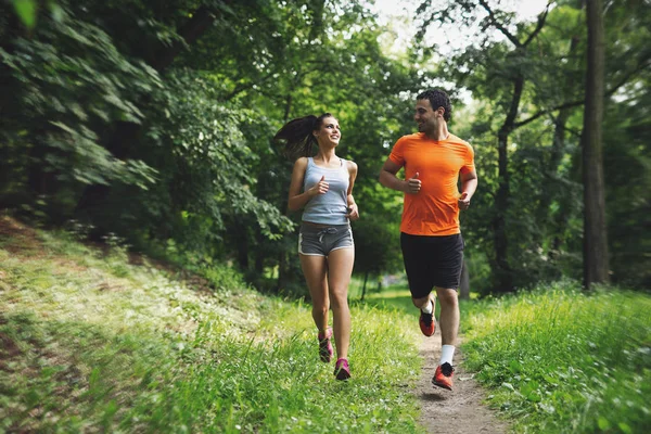 Happy couple running together — Stock Photo, Image