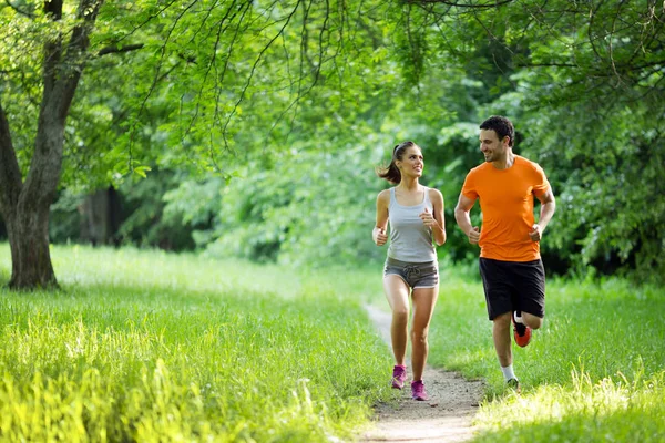 Happy couple running together — Stock Photo, Image