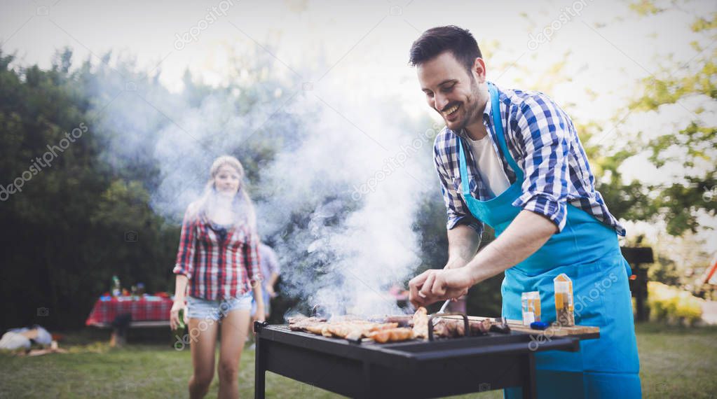 Happy friends enjoying barbecue party