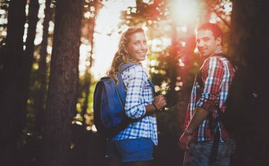 Couple hiking in forest clipart