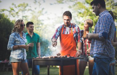 Mutlu arkadaşlar barbekü partisinin tadını çıkarıyor.