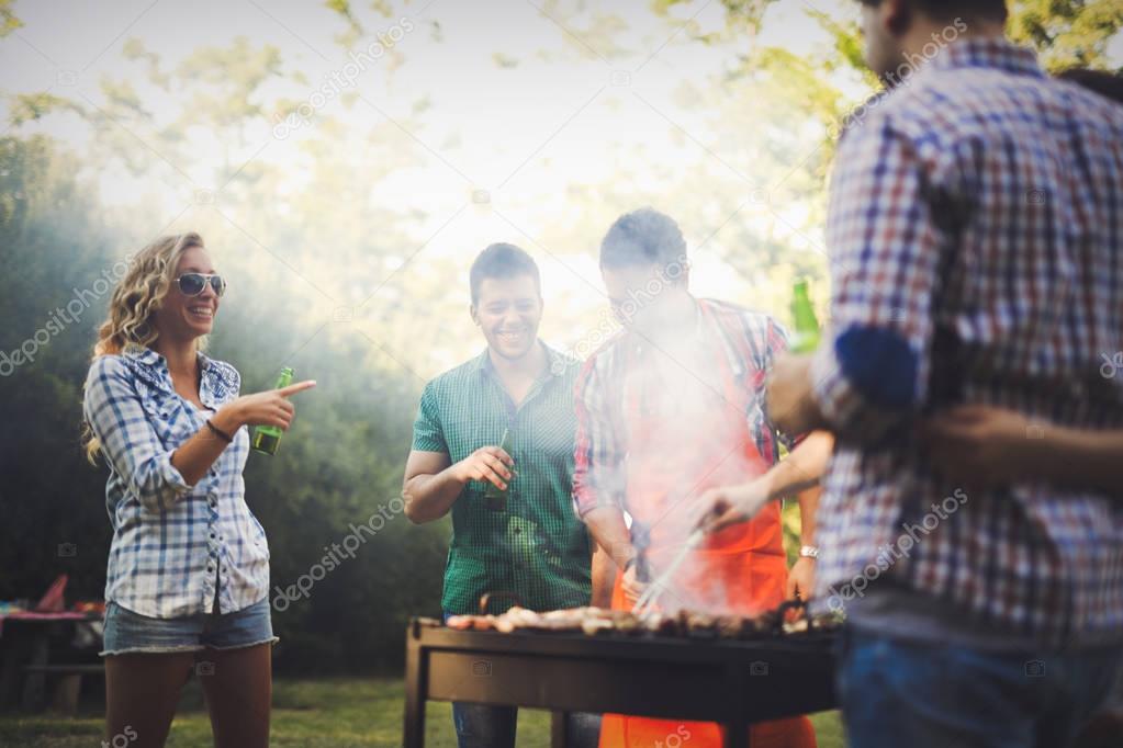 Happy friends enjoying barbecue party