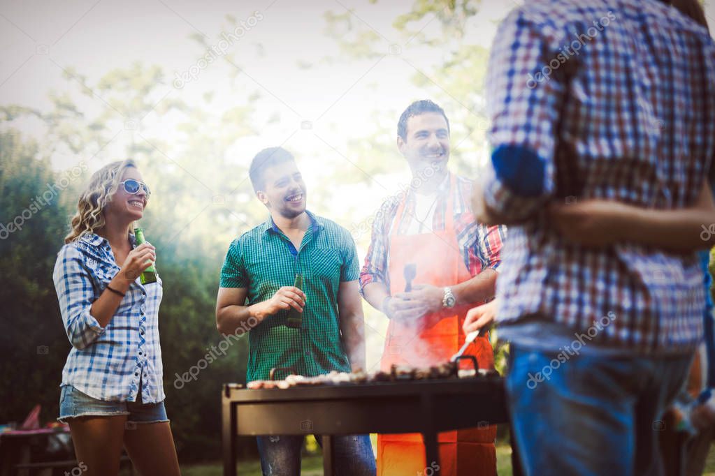 Happy friends enjoying barbecue party