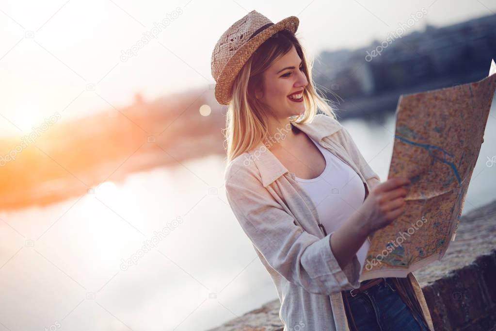 Happy blond female traveling and sightseeing