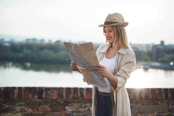 Happy blond female traveling and sightseeing