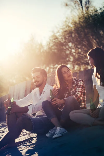 Happy vrienden feesten op het strand — Stockfoto