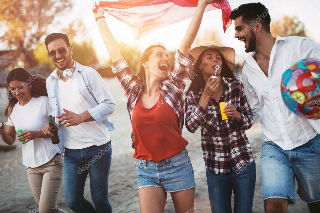 young friends having fun on beach