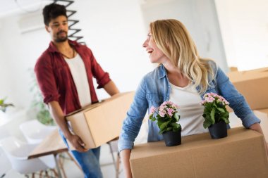 Genç çift yeni ev kavramı içinde hareket, karton kutuları açma