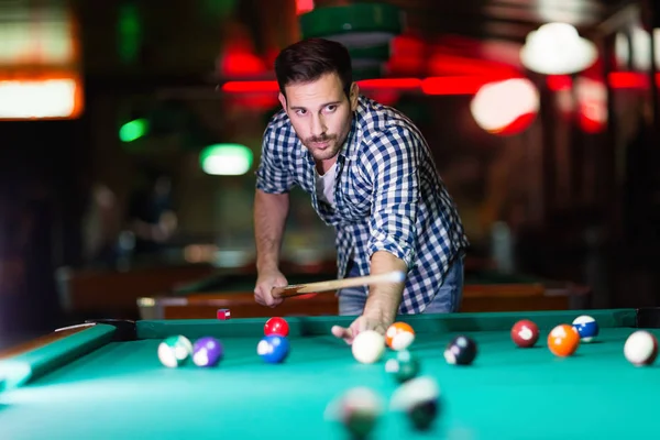 Hansome man playing pool