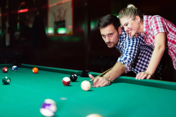 Couple playing together pool in bar Royalty Free Stock Photos