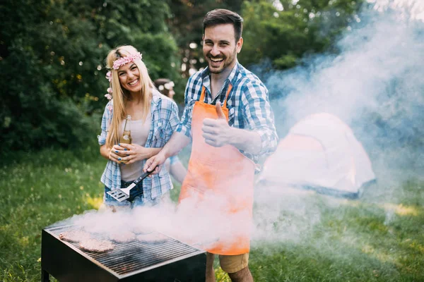 Beautiful woman and handsome man having barbecue — Stock Photo, Image