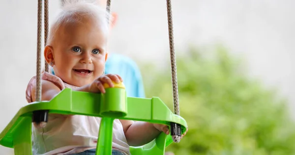 Glückliches Baby genießt Aktivitäten im Freien und lächelt beim Schaukeln — Stockfoto