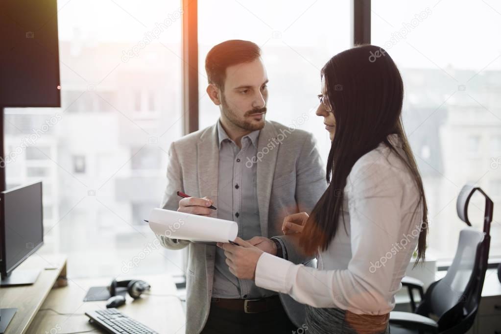 Picture of business couple discussing in office