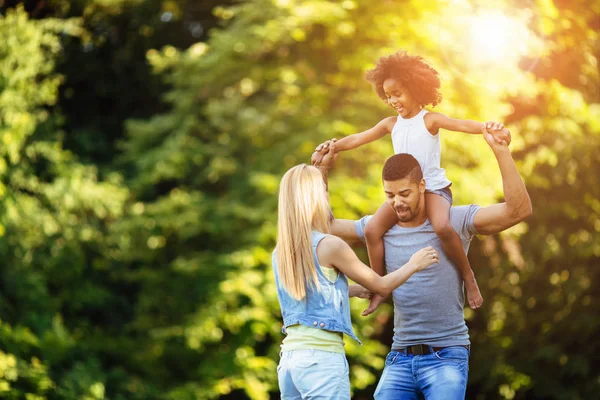 Picture of happy young couple spending time with their daughter — Stock Photo, Image