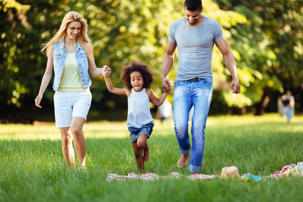 Happy young couple spending time with their daughter — Stock Photo, Image