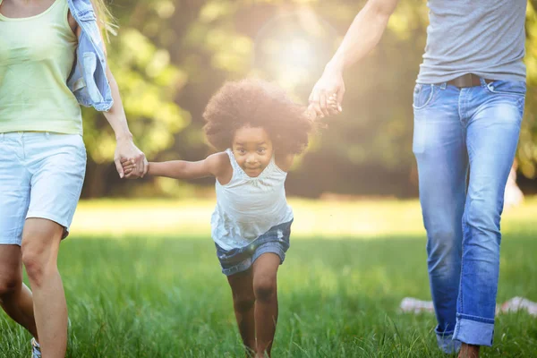 Happy young couple spending time with their daughter — Stock Photo, Image