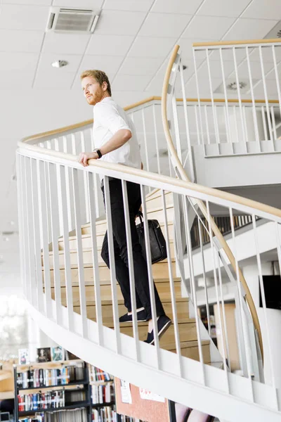 Businessman walking down the stairs