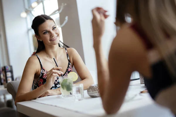 Beautiful women enjoying beverages — Stock Photo, Image