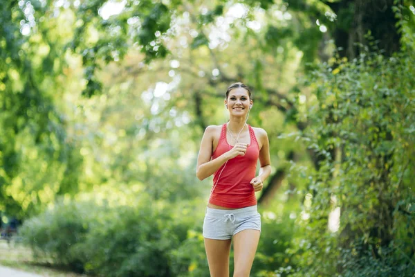 Young beautiful athlete jogging in park — Stock Photo, Image