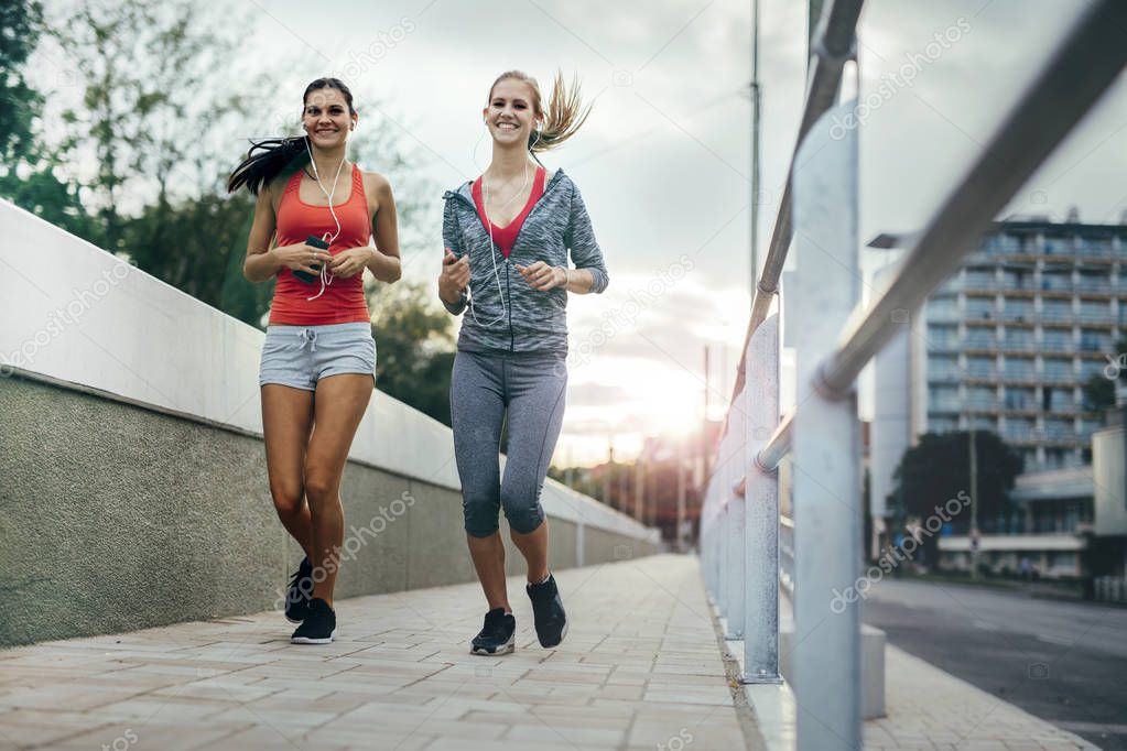 Two women exercising by jogging